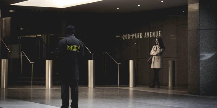 Security manager standing outside a commercial building