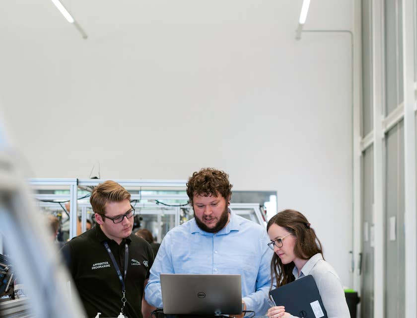 Senior DevOps engineer together with the software developers debugging the code of a program and looking for vulnerabilities before the official deployment