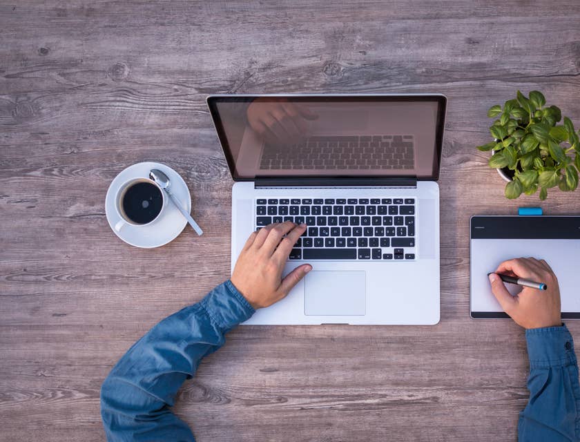 Senior graphics designer drawing new content while drinking a coffee