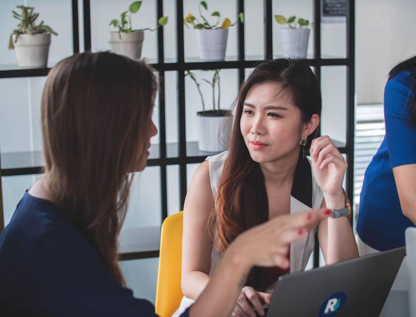 Senior sales executive guiding a newly hired sales representative on the best answers to clients' possible questions