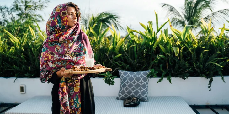 A woman holding a serving tray.