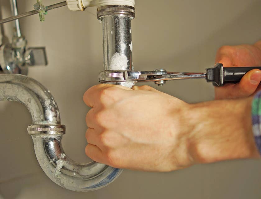 service plumber fixing a pipe