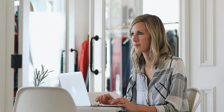 A shop manager creating work schedules for the employees.
