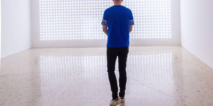 Showroom manager standing on an empty room visualizing the arrangement of stocks for the presentation