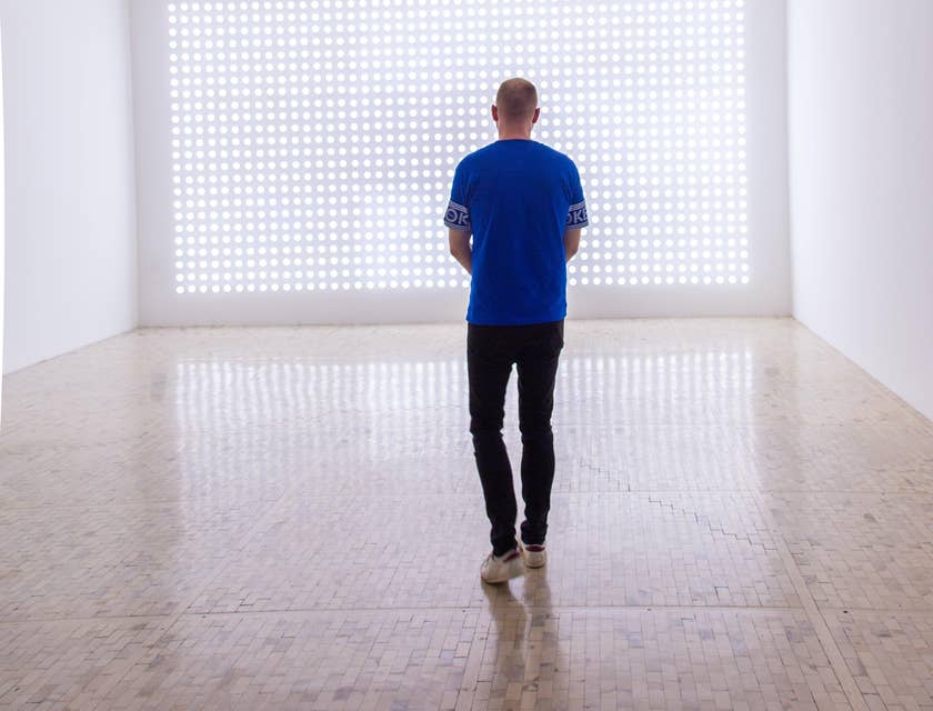 Showroom manager standing on an empty room visualizing the arrangement of stocks for the presentation