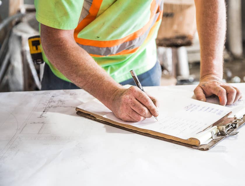 Site supervisor doing a checklist of construction site's progress.