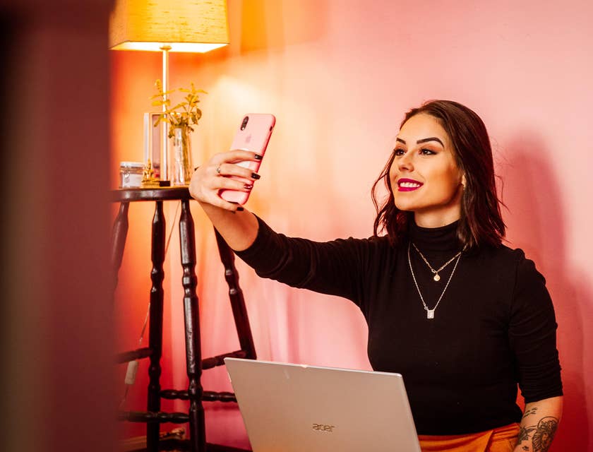 a social media influencer taking a selfie to promote beauty products on her social platform