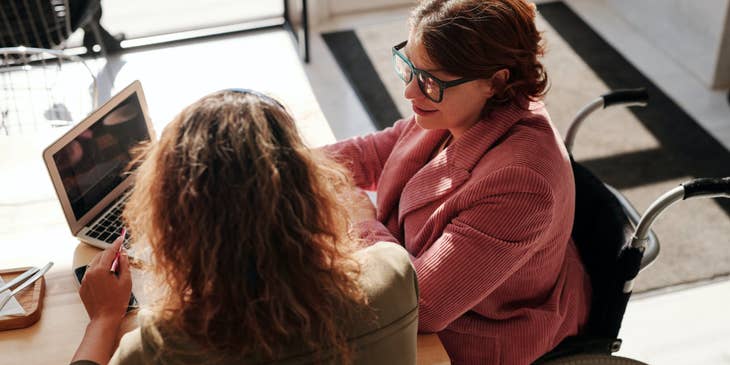 Social Worker Assistant assisting her client on filing the paperwork online