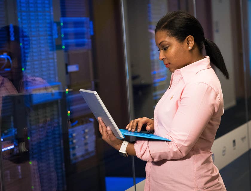 Solutions engineer checks system hardware while checking her laptop for a software upgrade