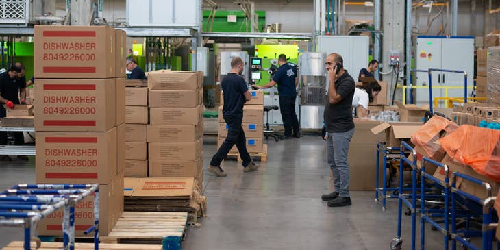 Sourcing specialist on the phone with a supplier to determine the price, quantity, and delivery schedule