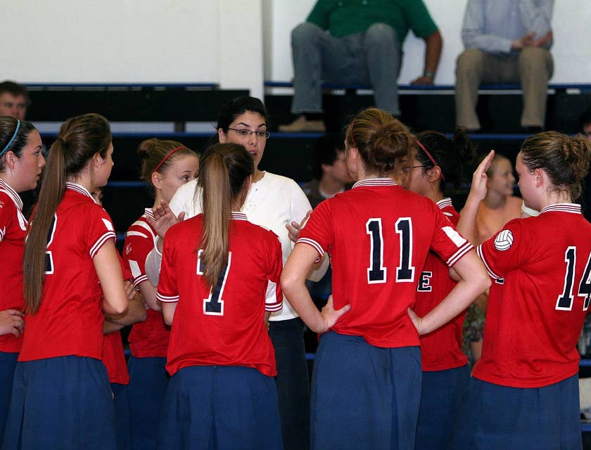 a woman coaching a volleyball team