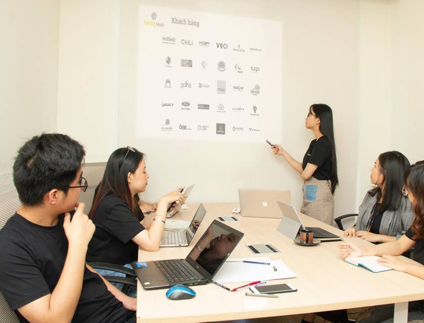 Sports Marketing Manager discussing to her team the sponsor logos that should be tagged on the merchandise