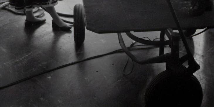 black and white photo of a stagehand working on a tv set
