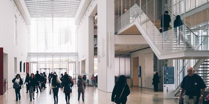 People walking in a concrete building.