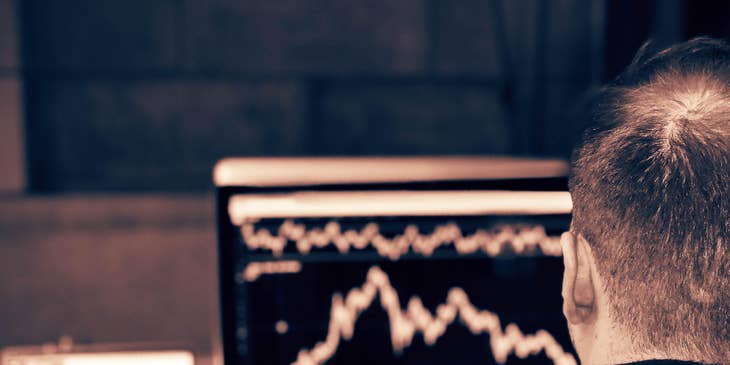 photo of a stockbroker watching the market fluctuation on his computer screen