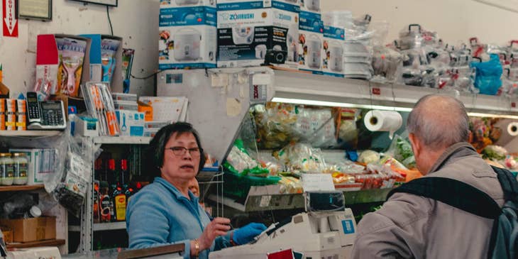 Store supervisor taking over the counter to deal with customer's complaint
