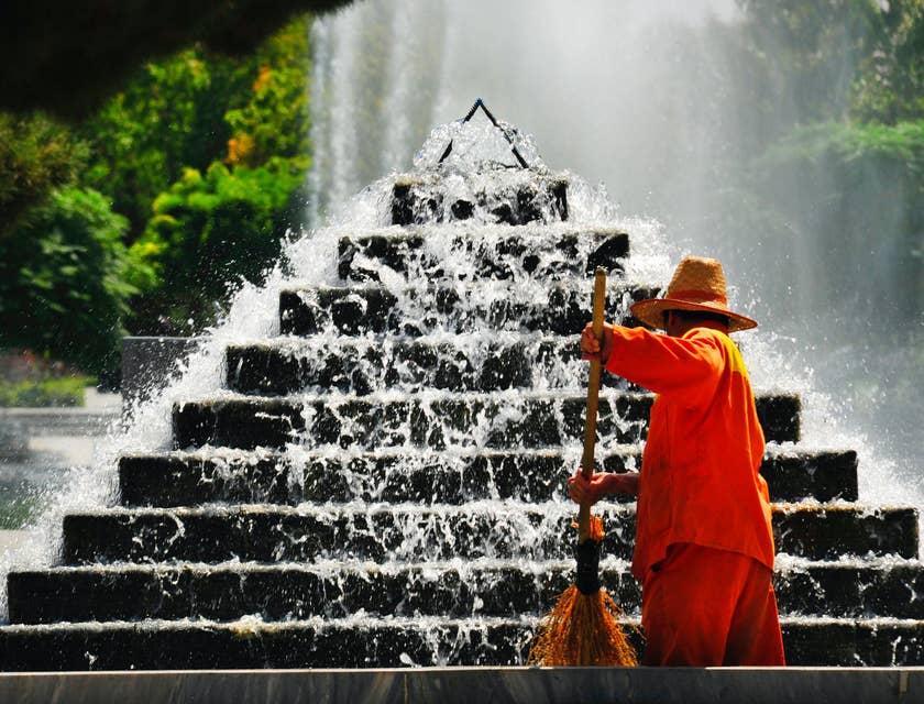 Street Sweeper Operator cleaning the surroundings of the fountain of a park