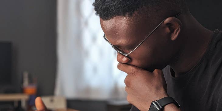 Student assistant reading a book and jotting down key parts to be used for a lecture