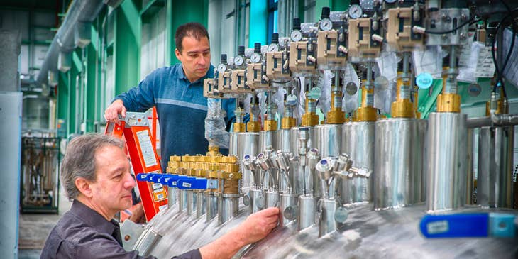Supply chain manager collaborating with the engineer as one of the machine malfunction and needs repair