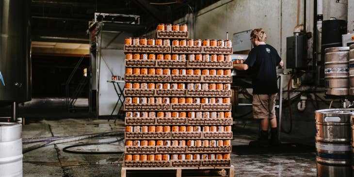 Supply chain manager checking pallets with stock in a warehouse