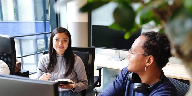 a Talent Manager taking notes while in a meeting with music producer