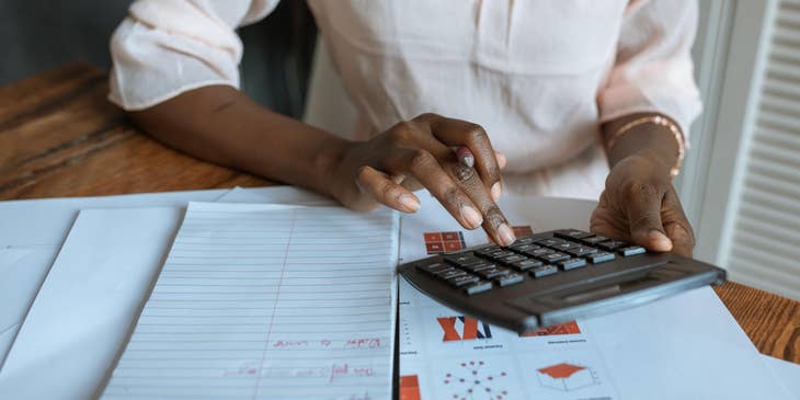 Tax auditor evaluating tax refunds while working on a report for a business company