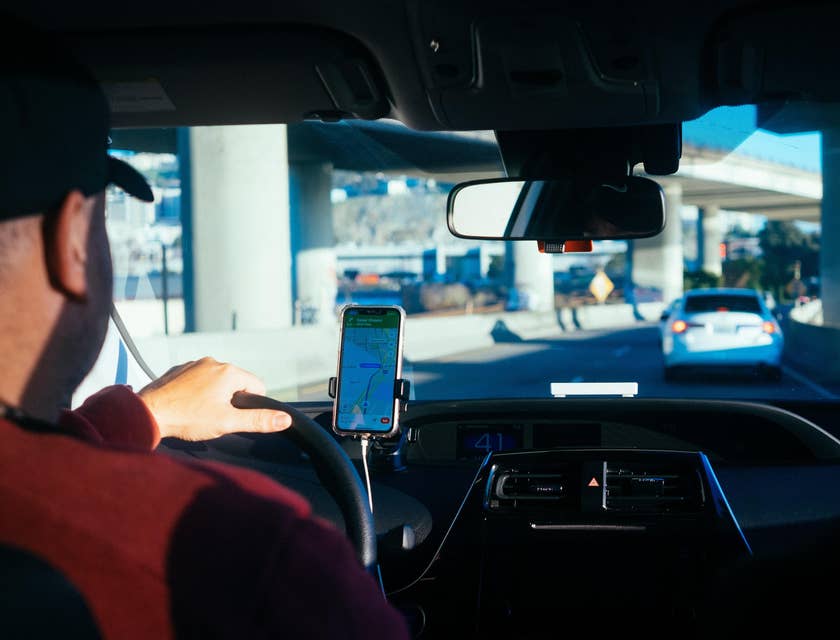 Taxi driver transporting client to his destination with the help of GPS