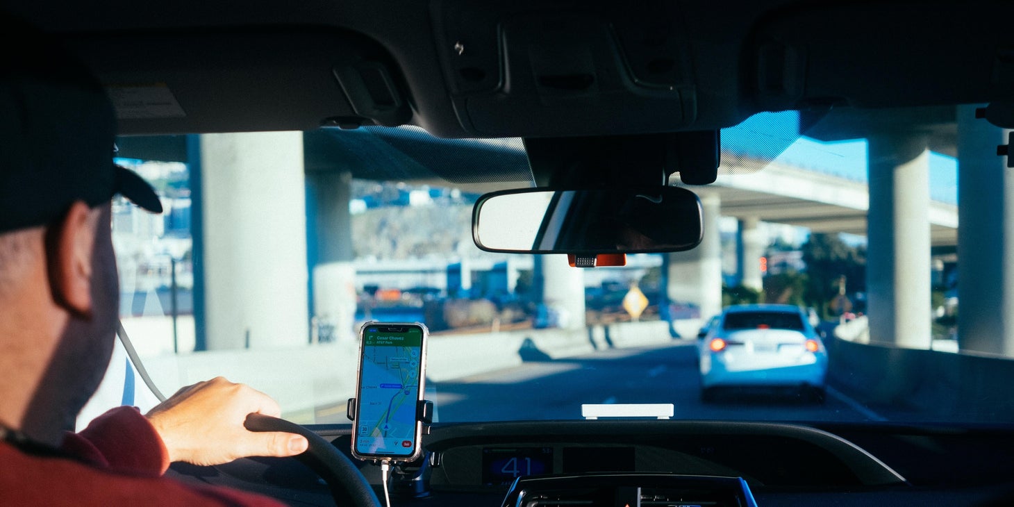 Taxi Driver transporting client to his destination with the help of GPS