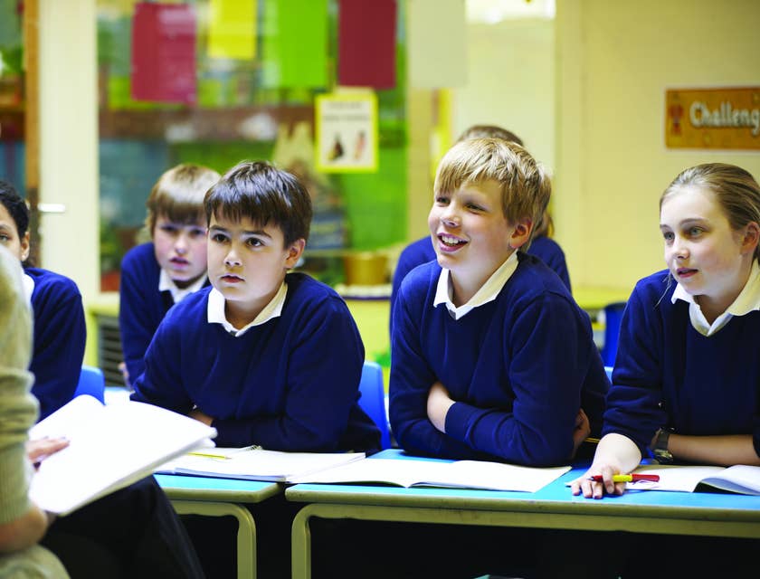 Teacher aide explains a new lesson to a chosen group of students