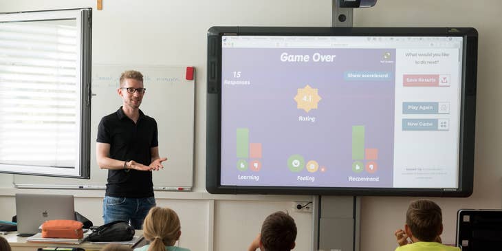 Teacher gives an interactive lesson to his students on a projector.