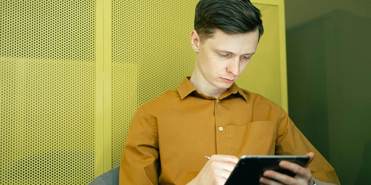 A technical editor proofreading the work of a technical writers for possible revision.