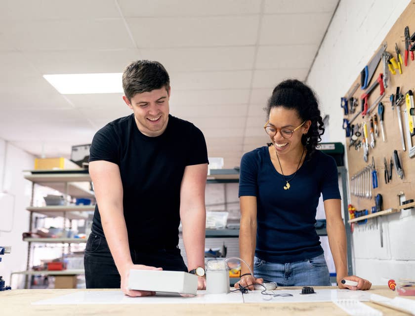 female technical engineer showing the product's test results to her colleague in a workshop