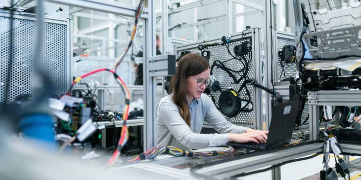 Test engineer running the test program for the newly manufactured product at a workshop
