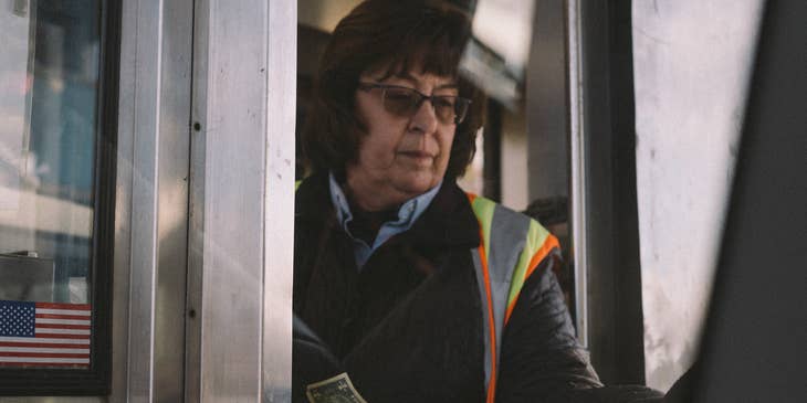 Toll collector on the booth receiving clients' toll fee