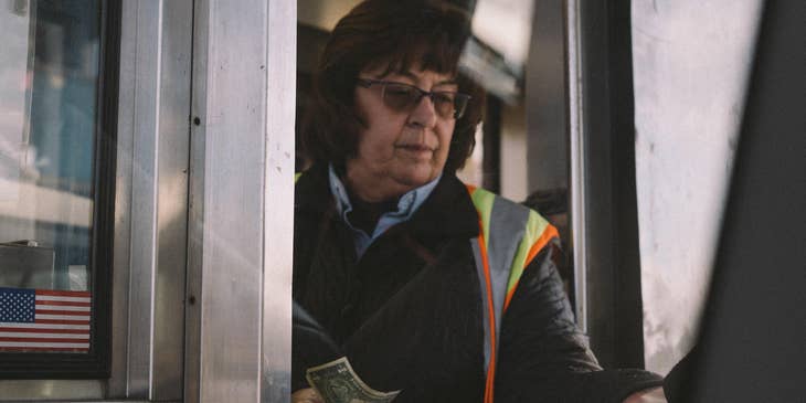 Toll Collector on the booth receiving clients' toll fee