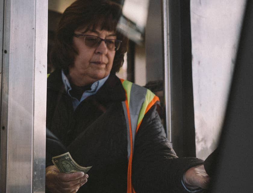 Toll Collector on the booth receiving clients' toll fee