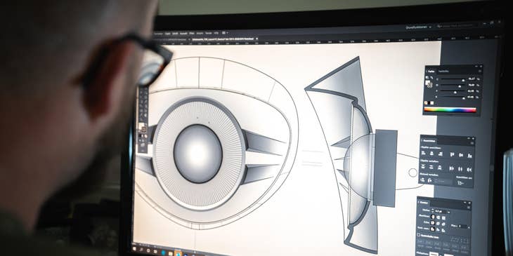 Tooling engineer working on a design using the CAD software on his workstation