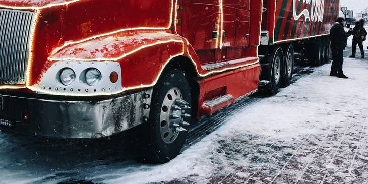 Tractor-trailer truck driver taking a quick break to stretch after a long drive