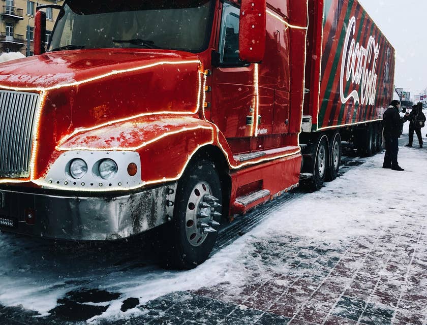 Tractor-trailer truck driver taking a quick break to stretch after a long drive