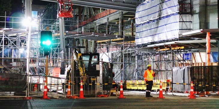 Traffic marshall ensuring security on construction site.
