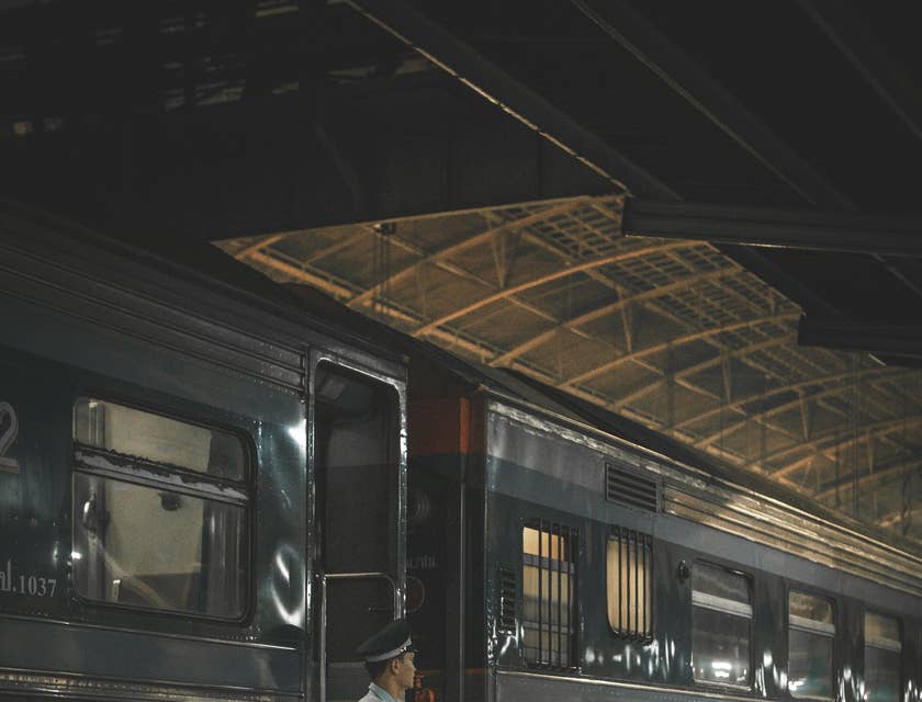 Train Conductor waiting for the passengers to go onboard
