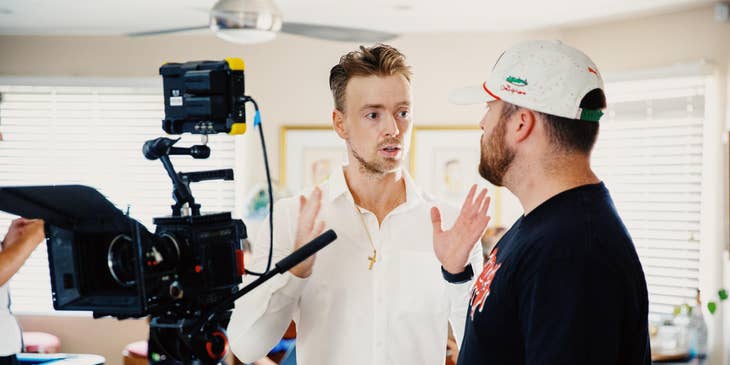 TV producer discussing the plans with a videographer