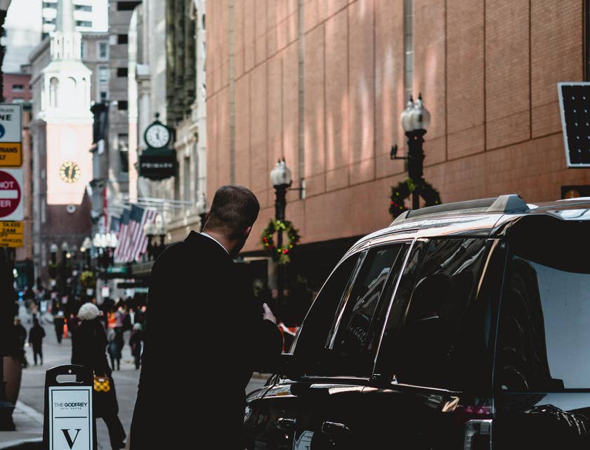 Valet attendant assisting a guest.