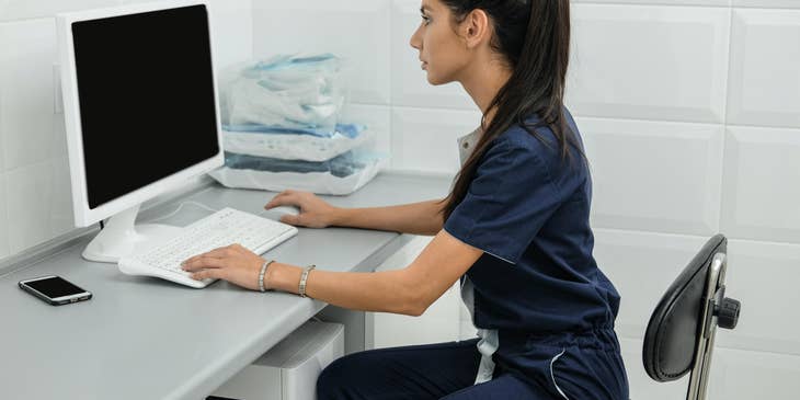 Veterinary receptionist sitting at her workstation and eager to start her day.