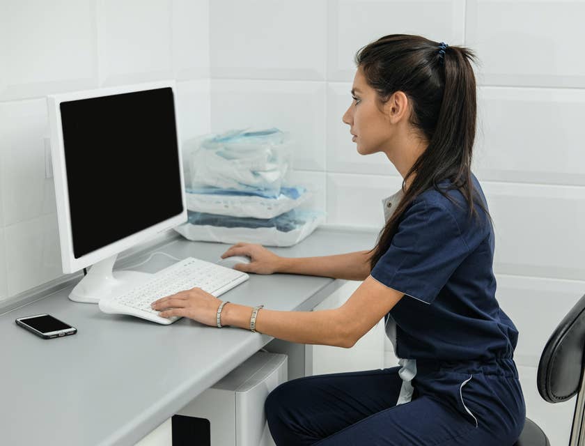 Veterinary receptionist sitting at her workstation and eager to start her day.