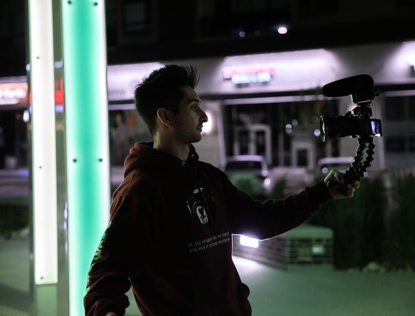 a Vlogger using his camera with tripod vlogging during nighttime