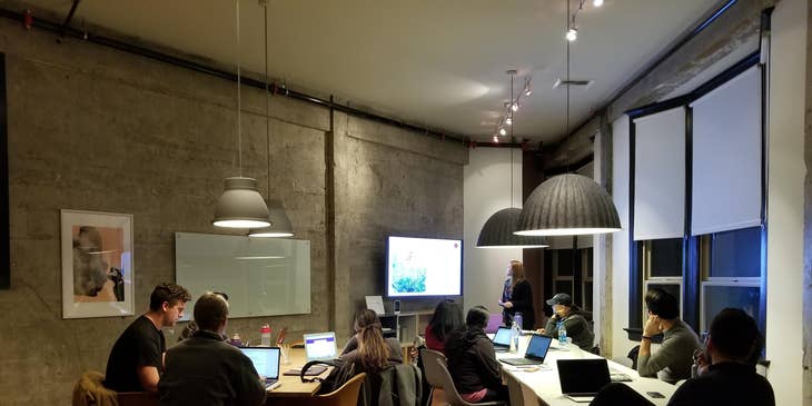 a group of engineers, developers, and their VP of engineering having a year-end meeting before taking their company vacation