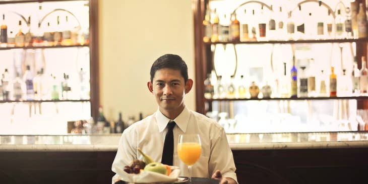 A Waiter about to serve food.