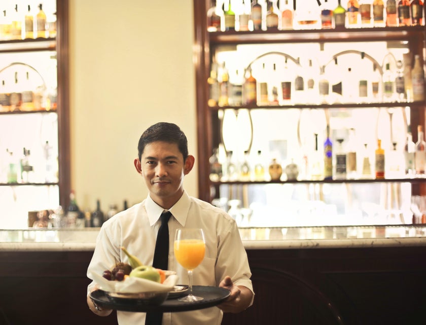 A Waiter about to serve food.