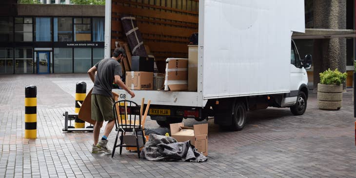 Warehouse driver loading the items to the vehicle before delivery